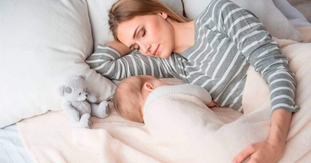 Mujer durmiendo con su bebé