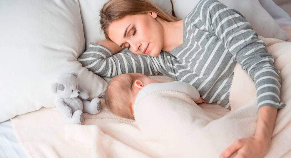 Mujer durmiendo con su bebé